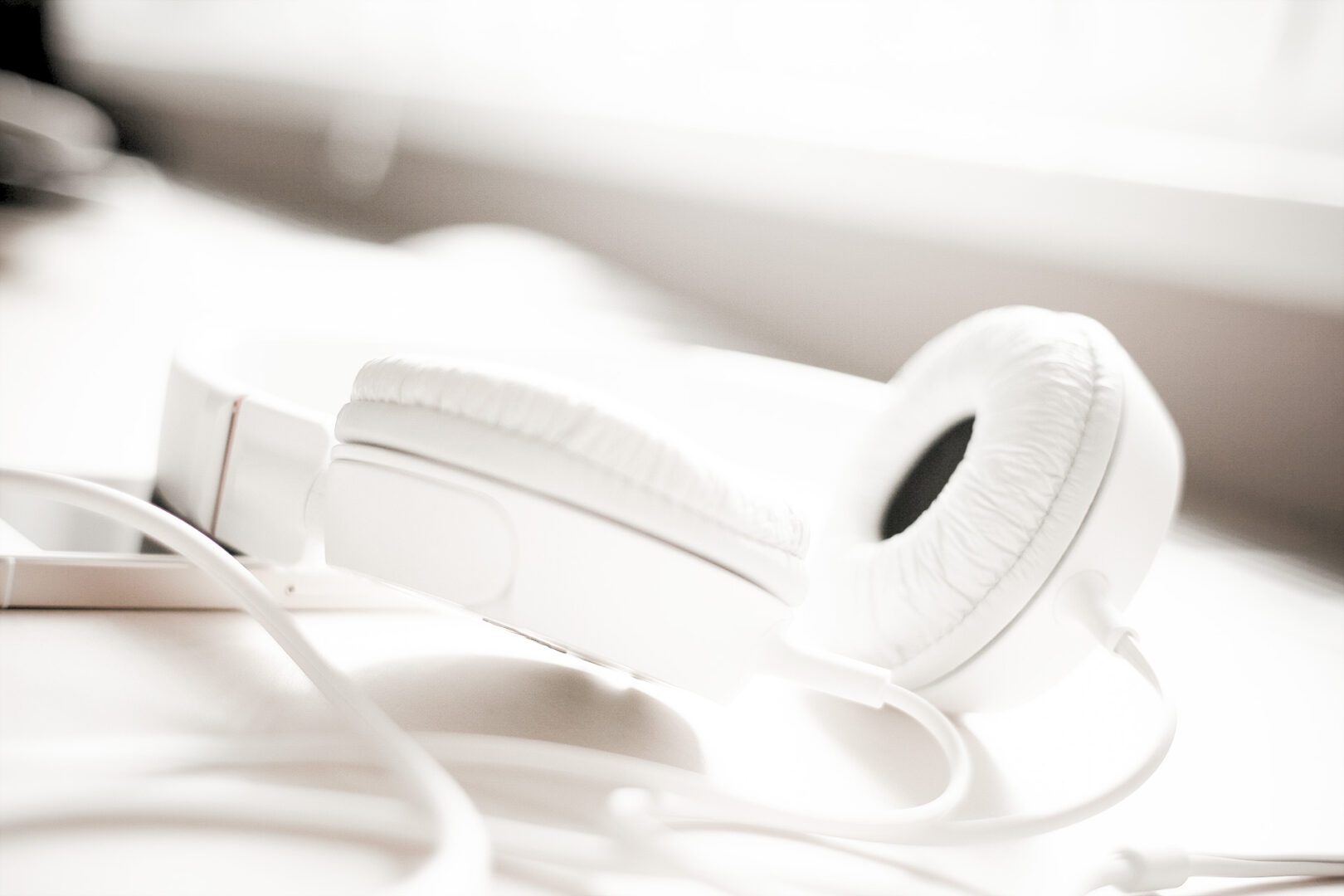 A white headphones sitting on top of some wires.